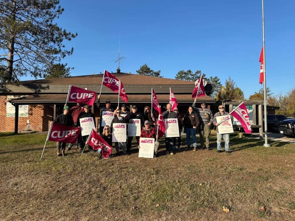 Members of Local 1813.06 - Town of Kearney demonstrating in from of Kearney Town Hall with CUPE flags and pickets.